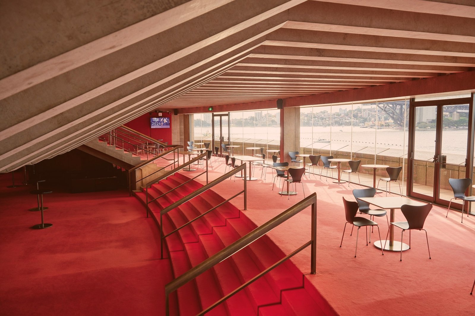 Theatre foyer with red carpet, staircase and lounge seating