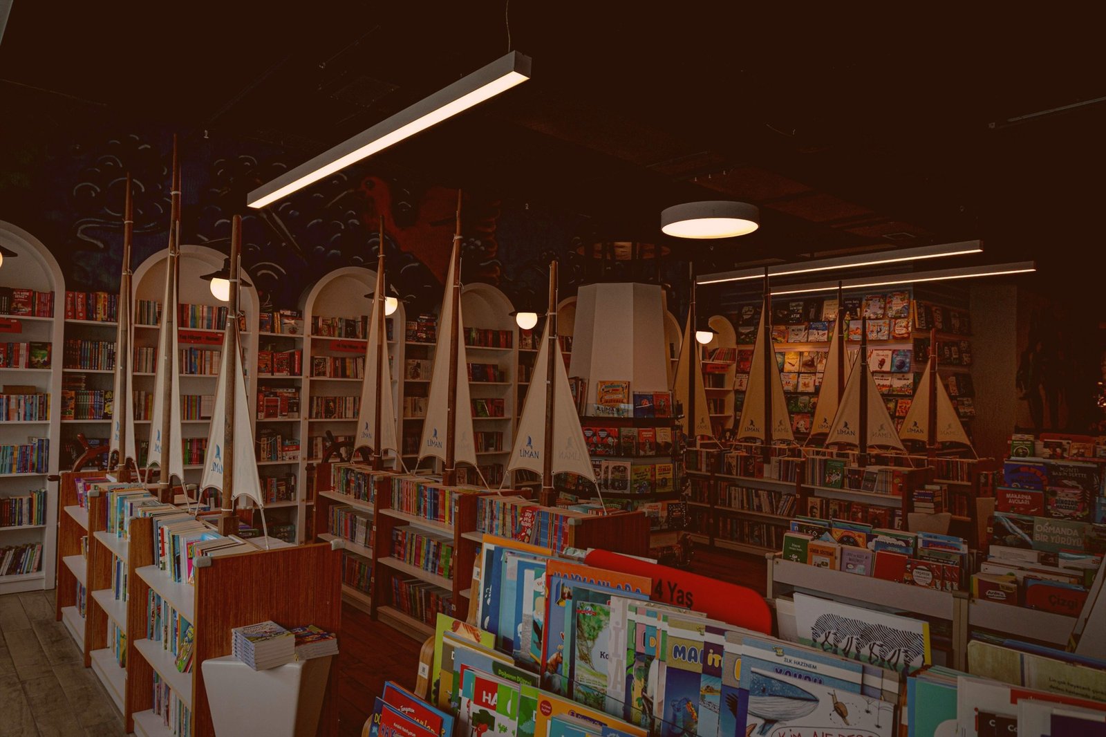 Museum store interior with bookshelves and model sailboats