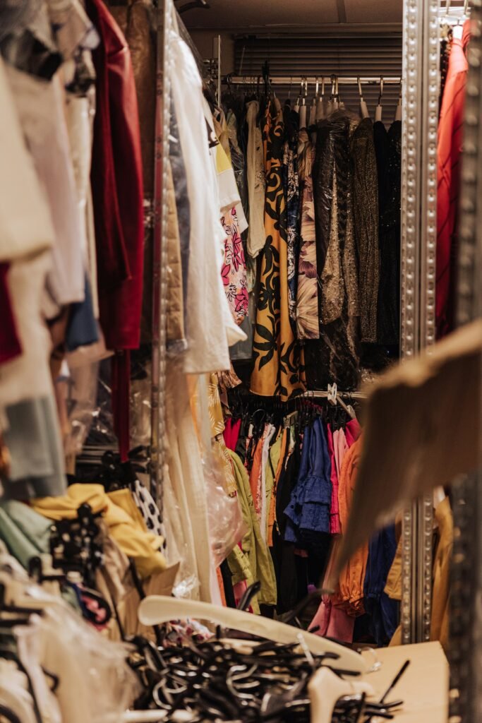 A backstage closet with clothes and ties. Photo credit Faruk Tokluoğlu on Unsplash.