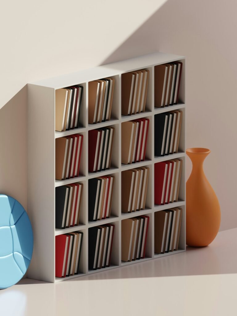 A bookshelf with a vase on a table. Photo credit TSD Studio on Unsplash.