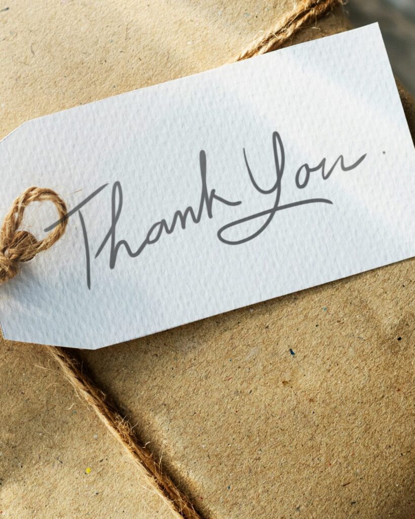 Kraft-paper gift tied with twine and a handwritten thank-you tag